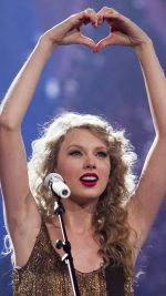 Singer Taylor Swift performs her song "Mine", as she kicks off her Speak Now North American tour in Omaha, Neb., Friday, May 27, 2011.  (AP Photo/Nati Harnik)
