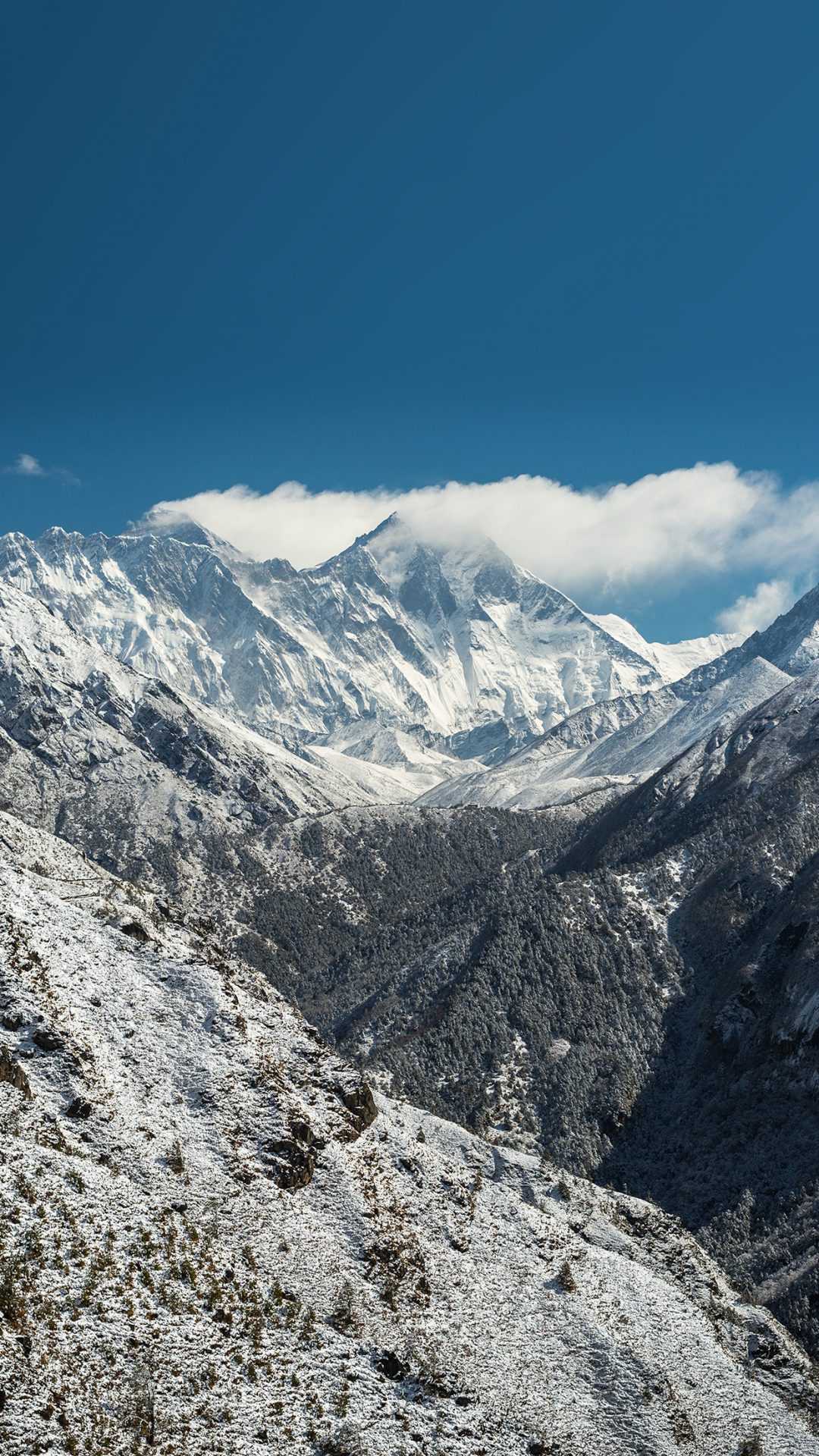 A stupa under snow (left) on the trail to Tengboche monastery (centre). Mt Everest (8850m) is making clouds just left of centre, with Lhotse (8498m) partly obscured just to the right. Far right is Ama Dablam peak.
